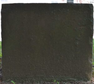 Photo of the side of the Emily Marguerite Holcombe marker associated with the 002 table stone, facing west.