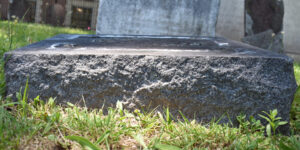 Background photo of the grass and base of a marker stone