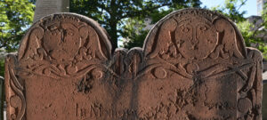 Image of Marker #563 - tympanum of dual headstone of Capt. Daniel & Mrs. Lucretia Sheldon - reddish brown stone