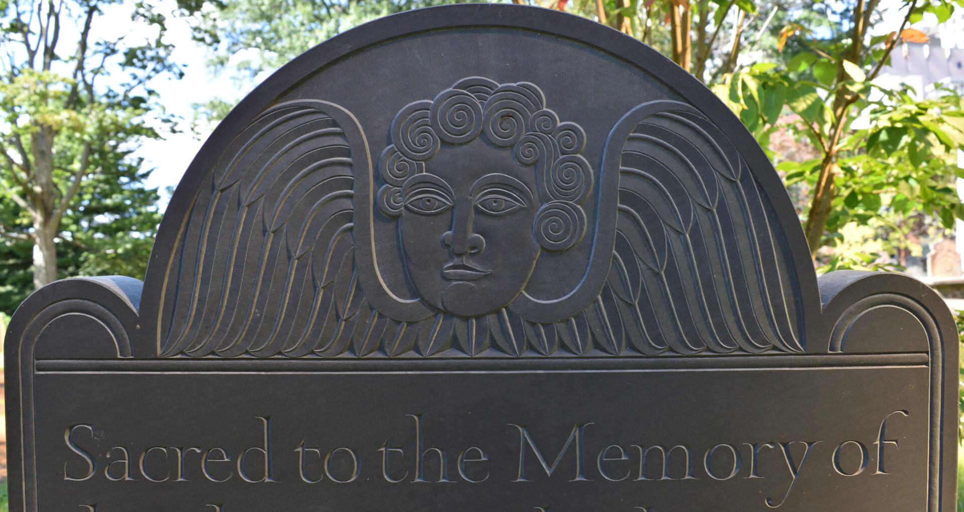 Detailed photo of the "tympanum" (decorative top section) of the African American monument's headstone